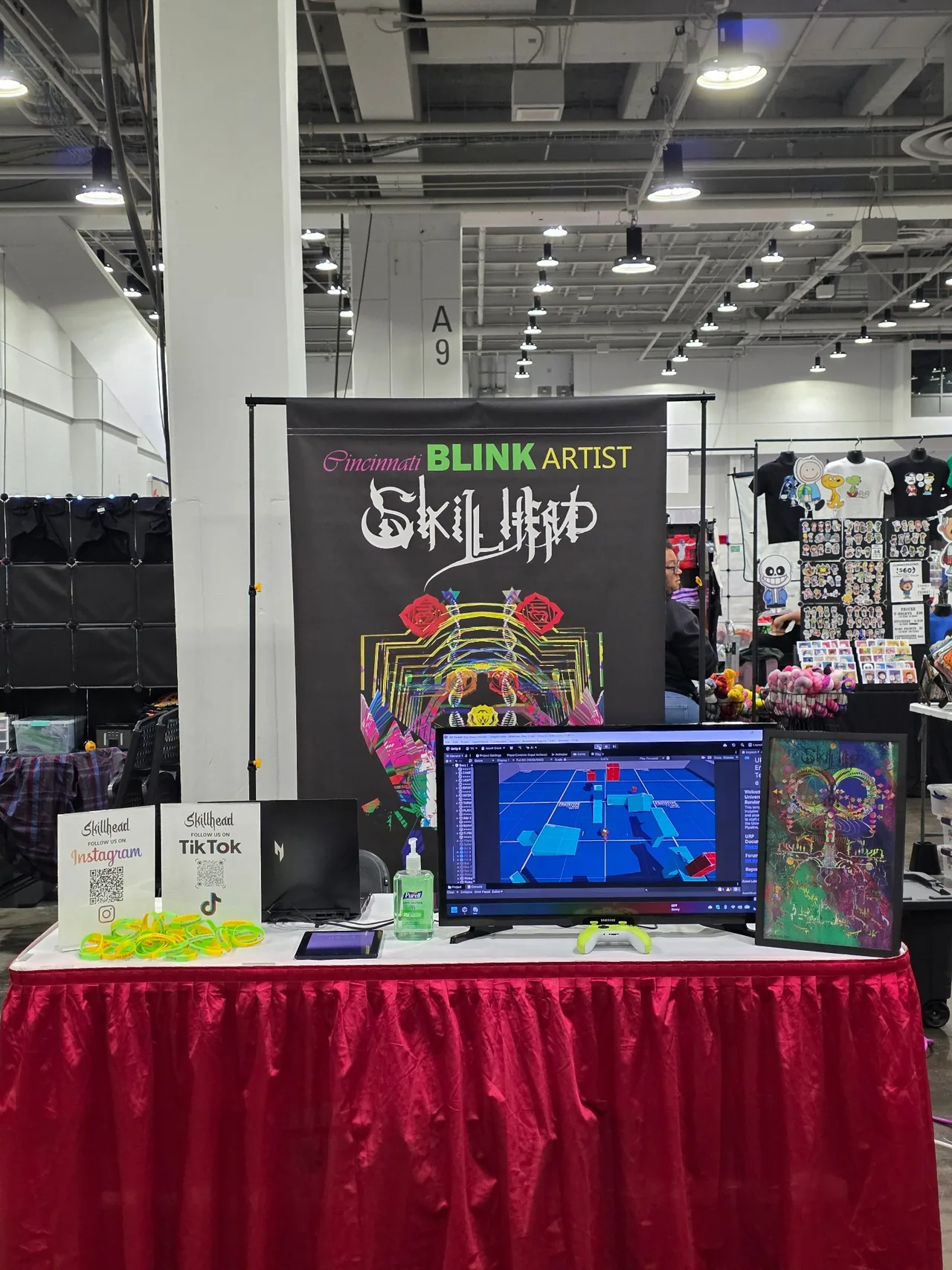 The ARBITRARY ZEN booth with Skillhead artwork, a game screen, and merchandise at Cincinnati Comic Expo 2026