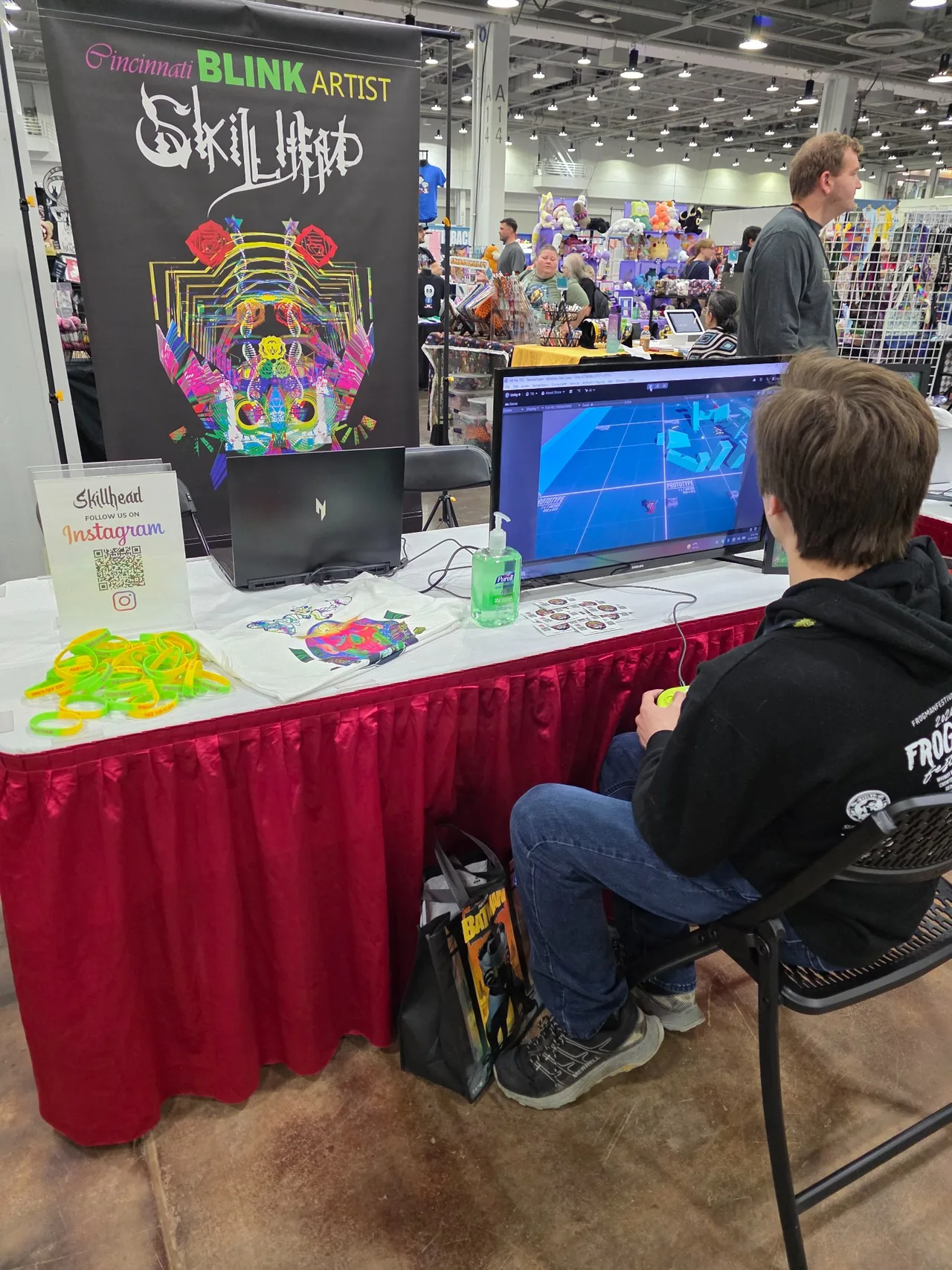 A visitor seated at the ARBITRARY ZEN booth trying a game at Cincinnati Comic Expo 2026